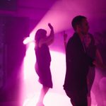 People dancing in a purple lit room at a Walker Art Center event