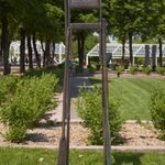 A metal sculpture outside in a garden.