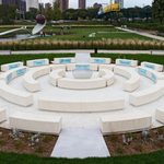 A white circular outdoor sculpture, with rows of seats in the circle.