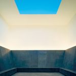 A square room with a square opening at the top, upper half of the room is white